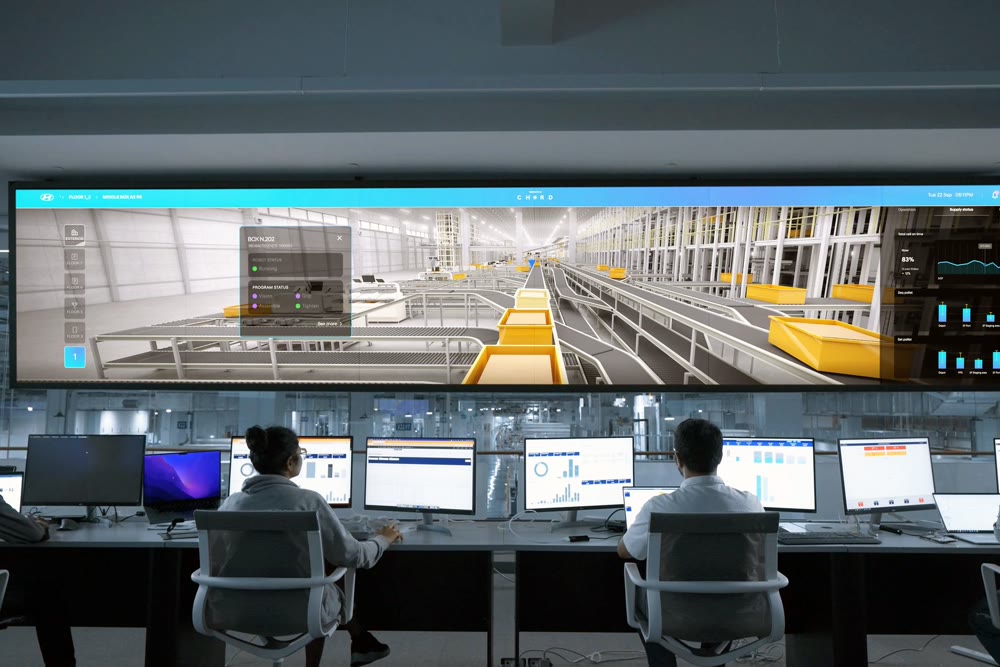 Operators monitoring a live digital-twin dashboard on a large control-room display — AI agents at work